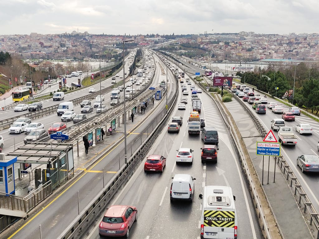 Photo of a ring road from the European side of Istanbul. You can see the lanes and platforms of the metro buses in the middle.