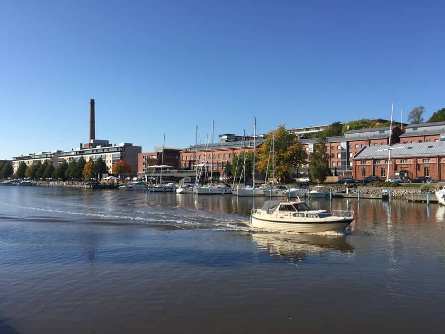 A boat sailing in Aura river in Turku in daytime